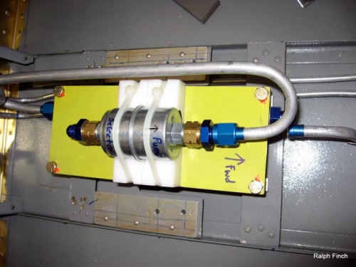 Upper line from filter to pump (below yellow plate)