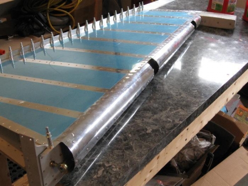 Theading edge is rounded and blind riveted.