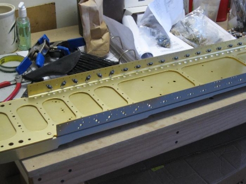 Nut plates riveted to the top flange of the right main spar.