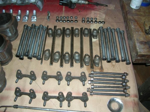 larger view of Valve train parts.  Large washer like part is the oil slinger from the oil pump housing