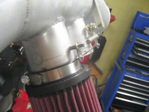 linkage moved from this position underneath butterfly arms to on top of arms