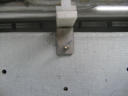 bolt head and channel bracket sitting on top of stringer