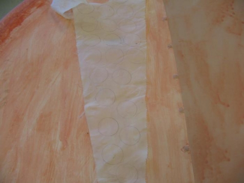waste fabric was attached to a board and ironed before the doily's were cut out for grommets.