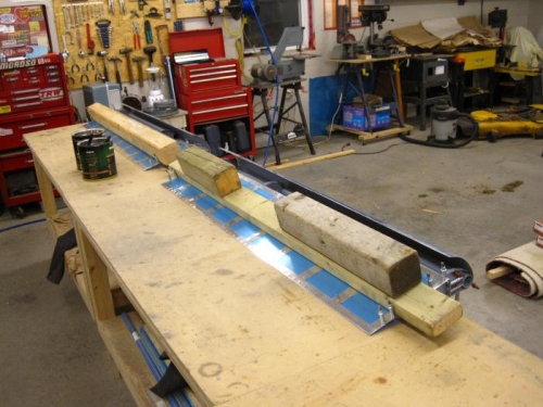 Boards keep aileron straight while drilling