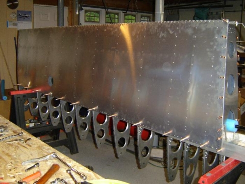 Bottom aft skin riveted.