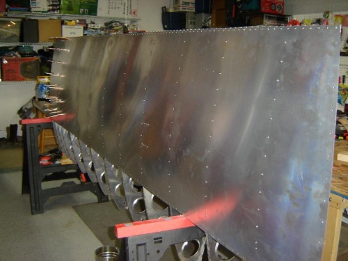 Top aft skin riveted.