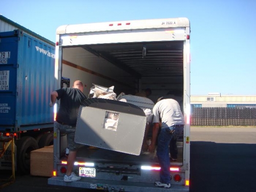 Van's employees loading the U-Haul with the quick build parts!