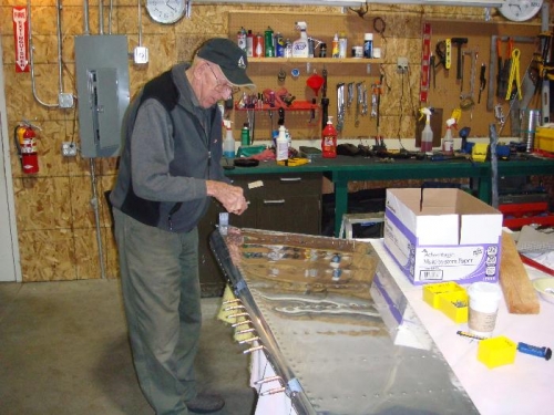 Dad setting final rudder rivets in place