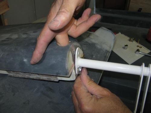 Holding the nut against the bolt end.