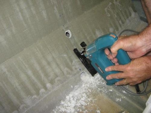 Cutting rudder cable holes and elevator bell-crank hole through seat back