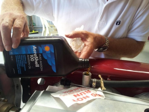 Adding 3 1/2 litres of Aeroshell 100.