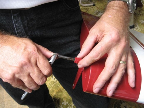 Tapping the paint out of the thread in the retained nut.