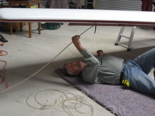 Feeding the cable puller through the wing.