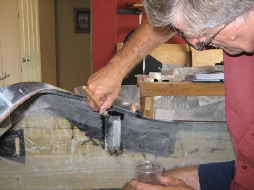 Glassing the panel mount bracket in place.