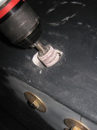 Drilling and sanding the fuselage holes.