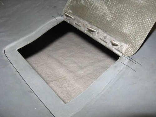 Hinge flocked and screwed to the cover.