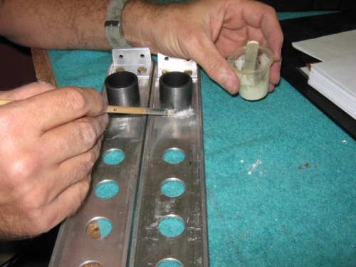 Expoxing the sleeves in place on the rudder support brackets.