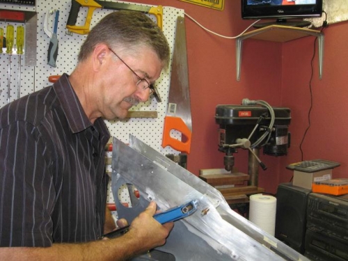 Riveting the top extension on the console.