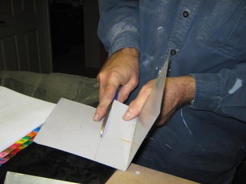 Cutting a template for the new frame brackets.