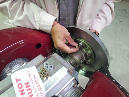 Bolting the spinner back plate behind the back of hub assembly