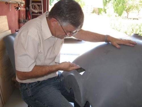 Trimming the cowl vent hole for the oil cooling duct.