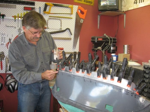 Clamping the glare shield to the supports.