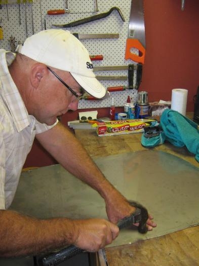 Mark hammering the edges smooth.