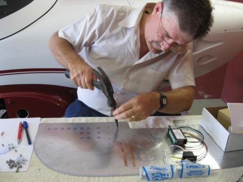 Punching, and then drilling, the firewall to take the bus bars.