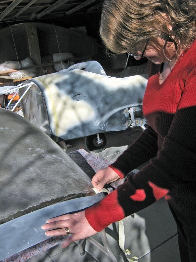 Sheryl helpimng to remove tape from canopy.