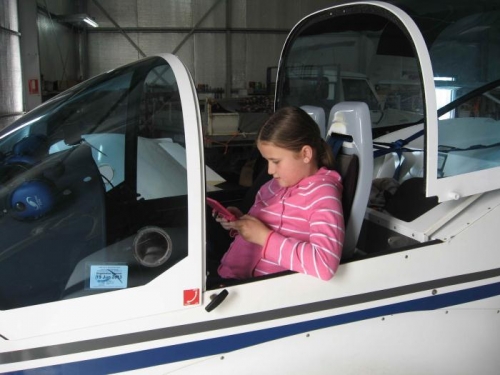 Grand-daughter Danielle playing flying games on her DS while in the Texan...