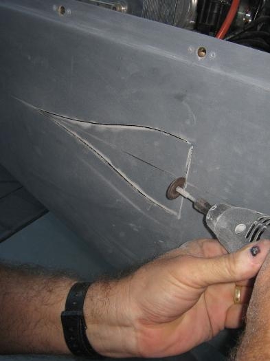 Cutting the well-undersize hole through the lower engine cowl.