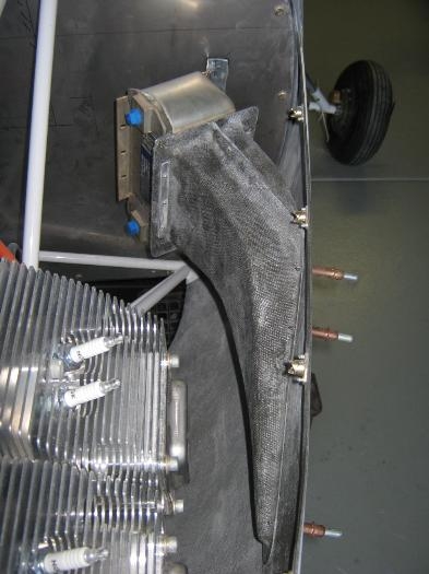 The angle supporting the oil cooler riveted to the firewall.