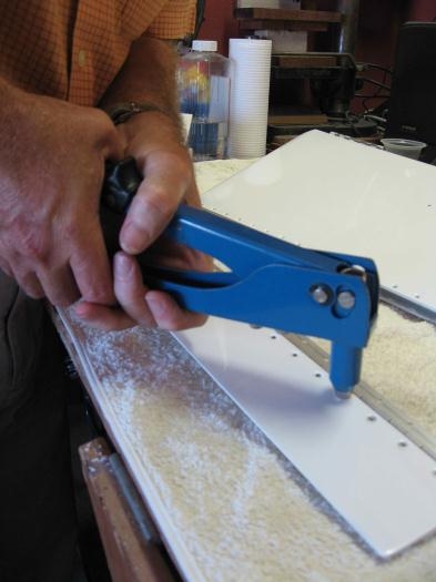 Riveting the hinge in place