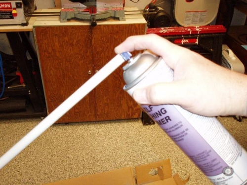 Spraying primer in the tube.