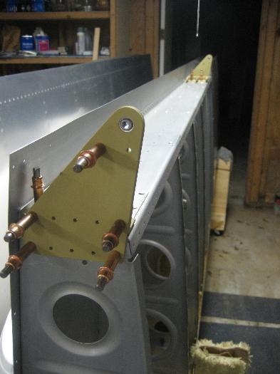 Aileron attach brackets cleco'd to the aft end of wings