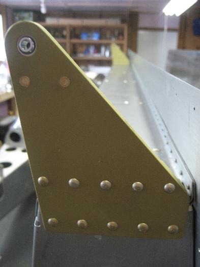 Right wing outboard flap attach bracket riveted on.