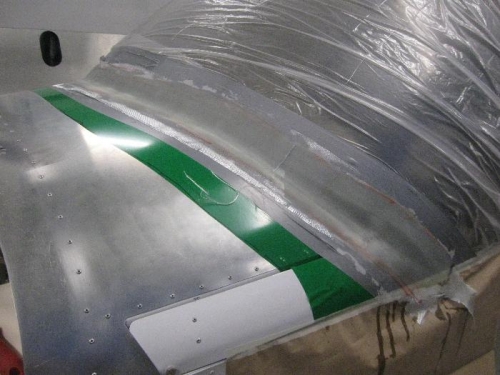 The green material is sign makers vinyl to protect the alloy from epoxy drips