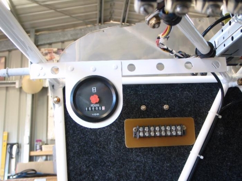 hour meter ,bracket manufactured and mounted just forward of dash panel