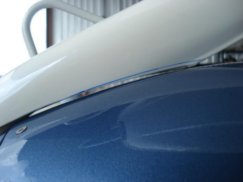 Strut fairing marked for trimming.