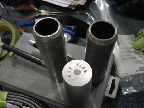 Two wing pins and the new tool.