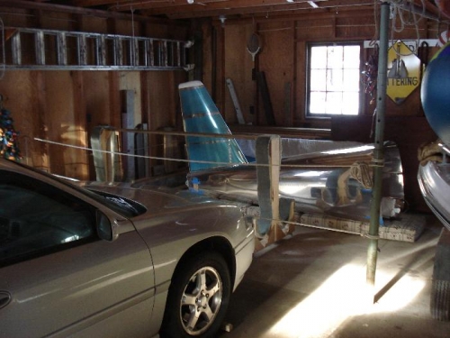 Airplane storage in roped off section of garage.