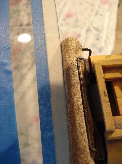 Cutting away plexi with sander.