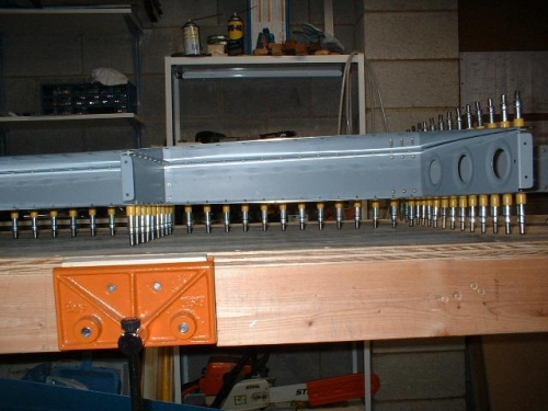 Inside view of left top skin riveted to front spar and ribs