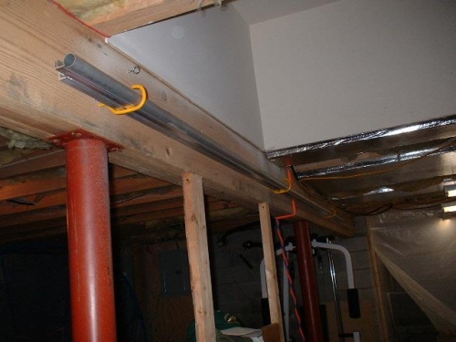 Longerons and Tubing hung along main floor joist in basement