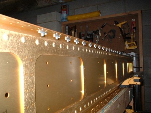 Nutplates riveted on top left flange
