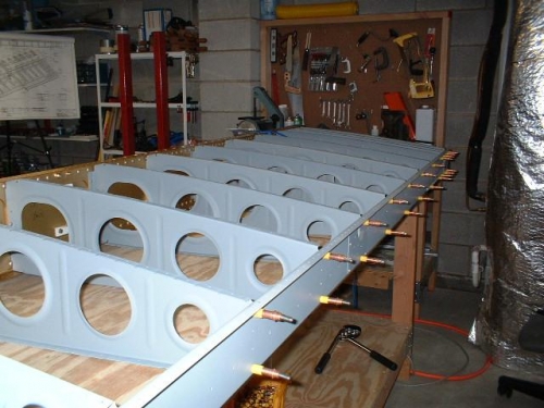 Left main ribs riveted to front spar; rear spar clecoed to ribs