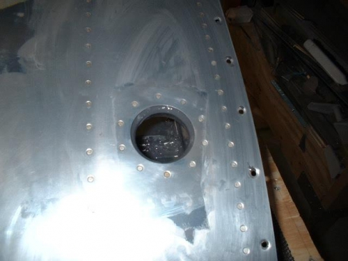 Fuel filler flange riveted in place