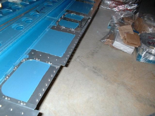 Inboard access panel nutplates riveted to skin