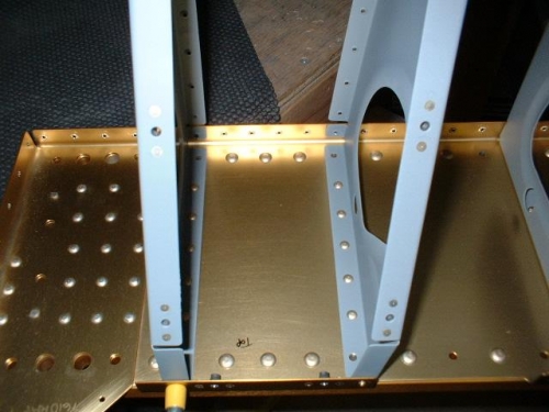 Seat ribs riveted to forward center section bulkhead