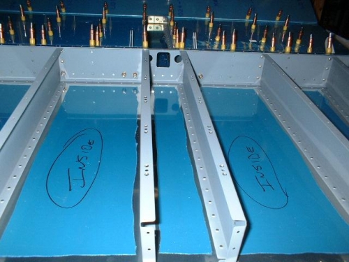 Seat floor skins drilled to center section